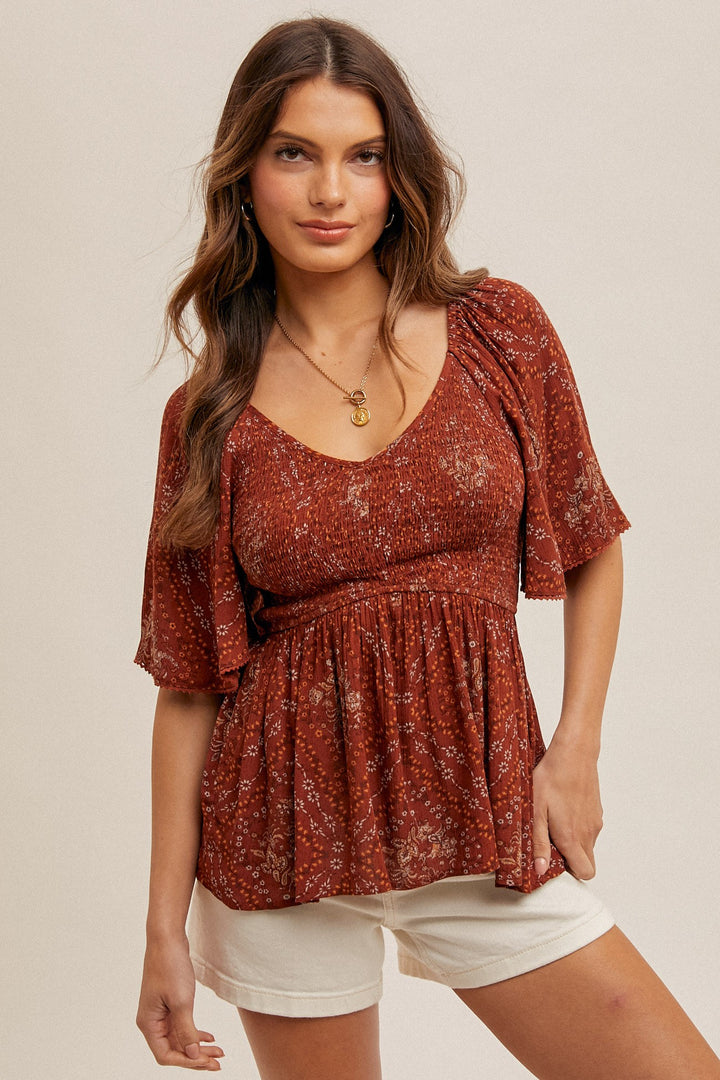 PRINTED FLUTTER SLEEVE SMOCKED PEPLUM TOP - RUST