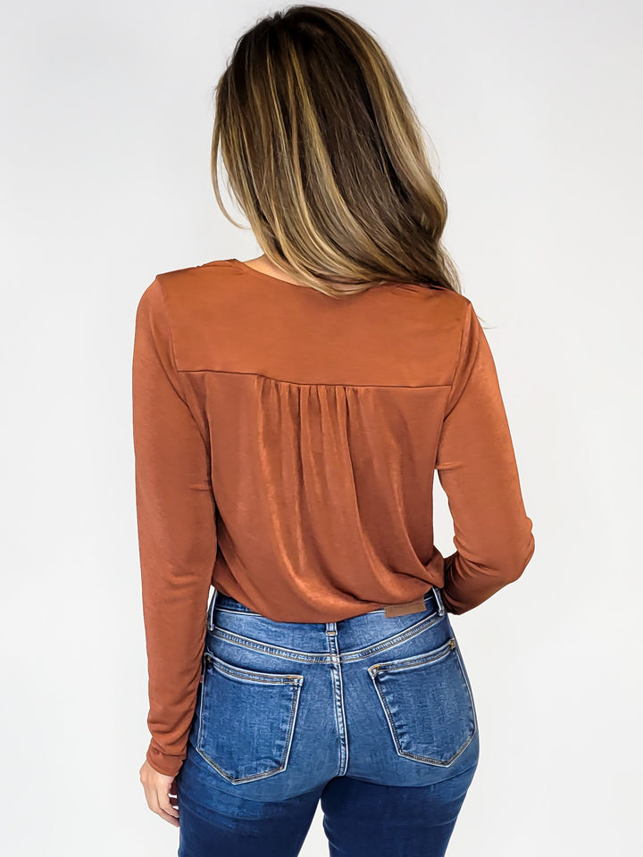 CROSSOVER STRETCHY LONG SLEEVE BODY SUIT - RUST